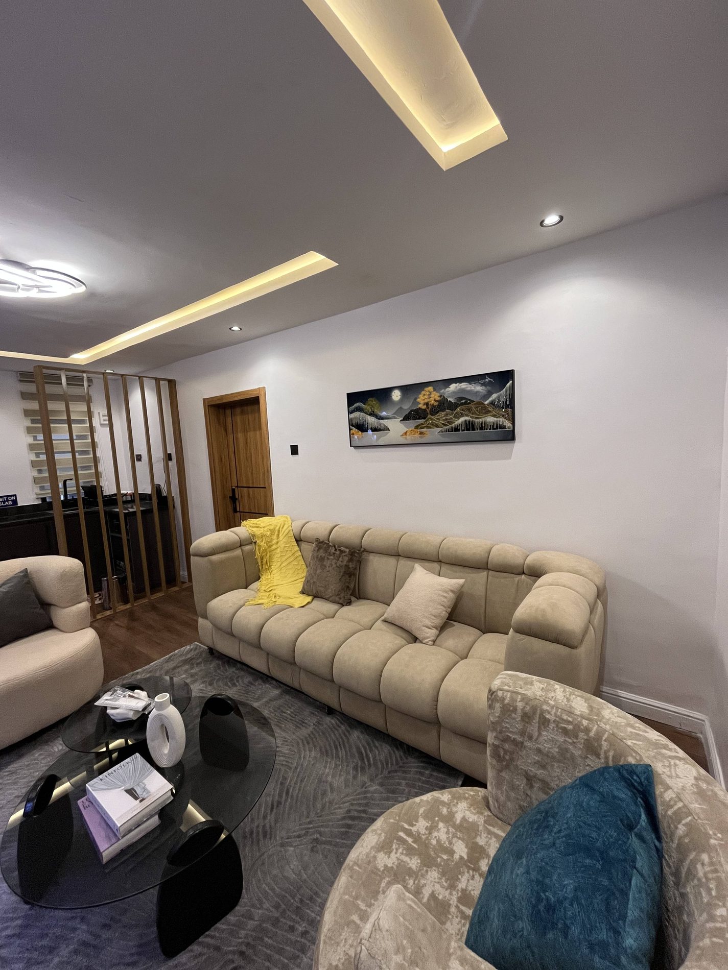 Emperor Suites neutral lounge with warm ceiling lighting