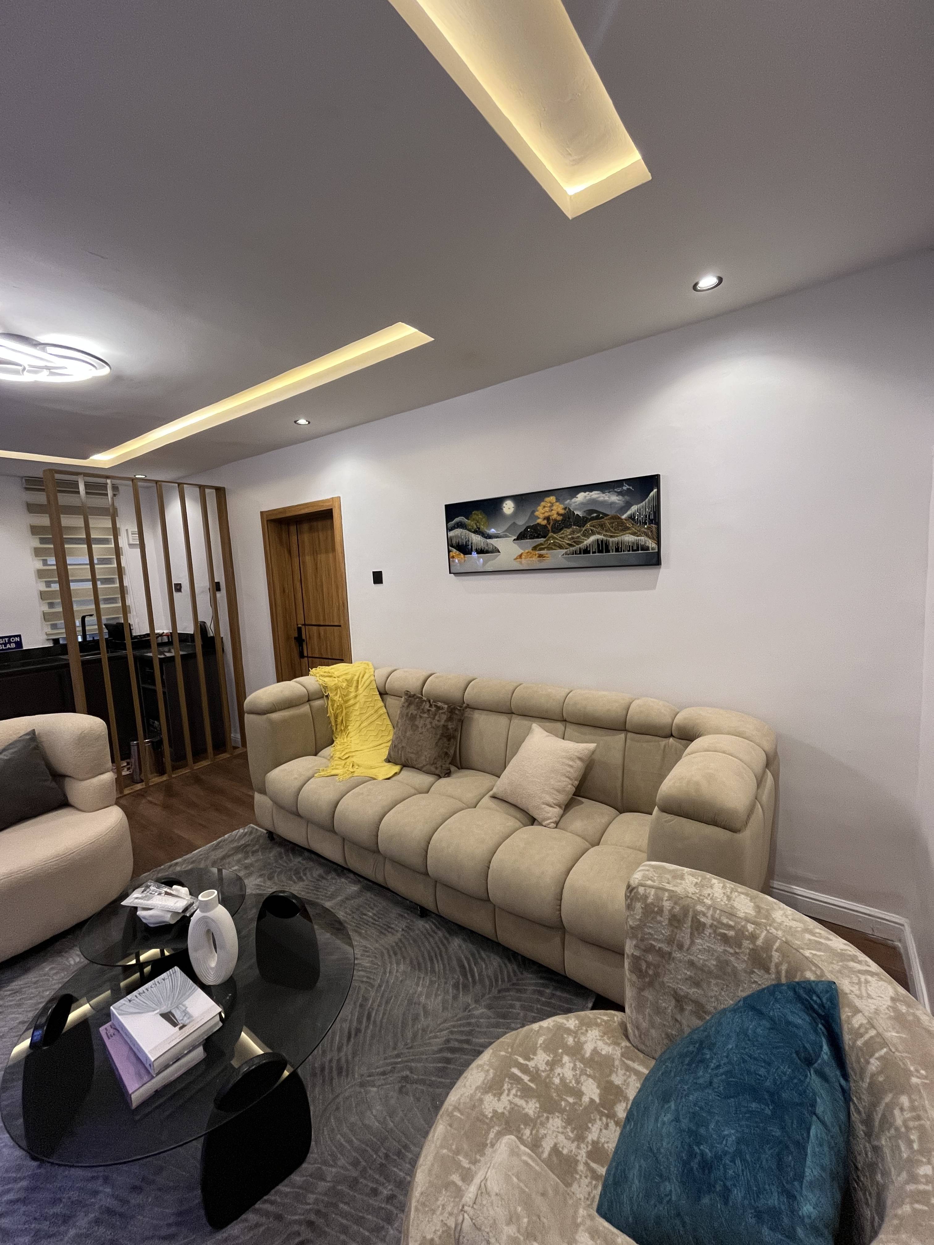 Emperor Suites neutral lounge with warm ceiling lighting